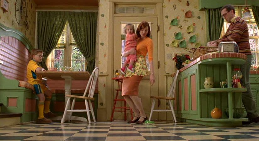 Geena Davis holding little girl in kitchen scene