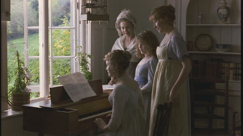 women gathered around a piano in Barton Cottage