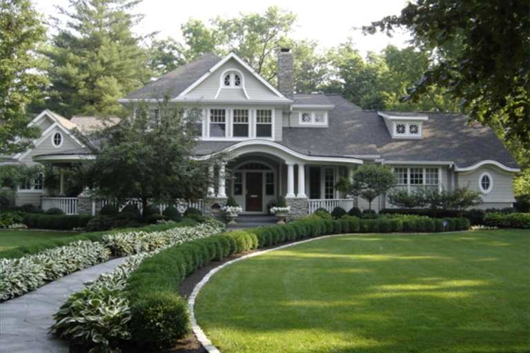 large gray house with curving walkway