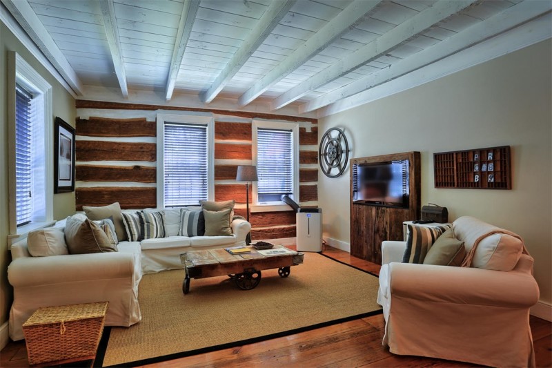 A living room filled with furniture and log walls