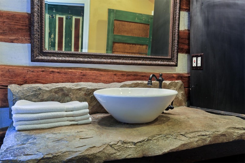 close up of sink in bathroom and stone countertop