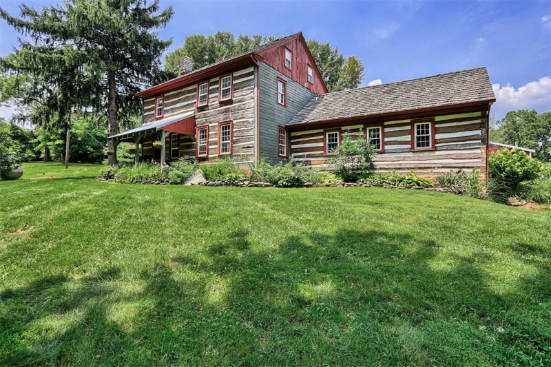 front exterior of two story log home with front porch