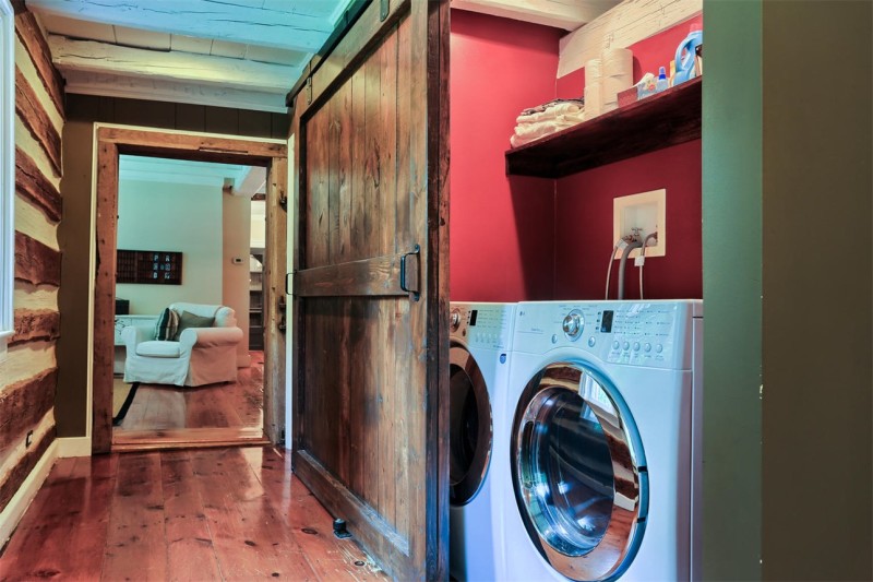 laundry room with washer and dryer behind barn doors
