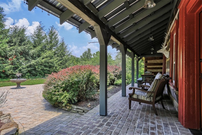 porch with brick paver floor