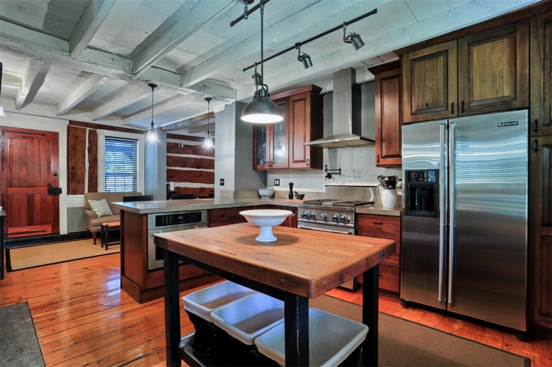 A modern kitchen with stainless steel appliances and wooden cabinets