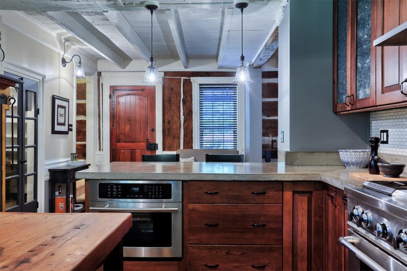 A kitchen with stainless steel appliances and wooden cabinets