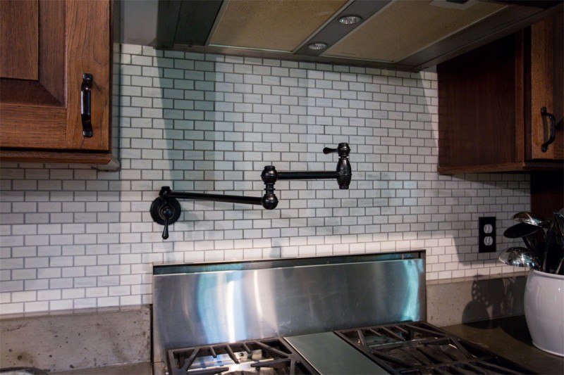 A kitchen stove with pot filler