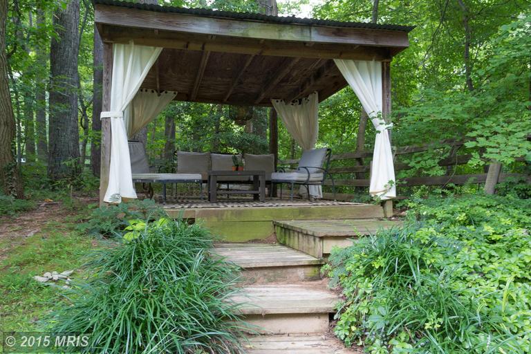 shelter in backyard with curtains and outdoor furniture