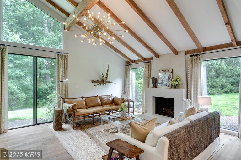 living room with vaulted beamed ceiling, sputnik chandelier and fireplace