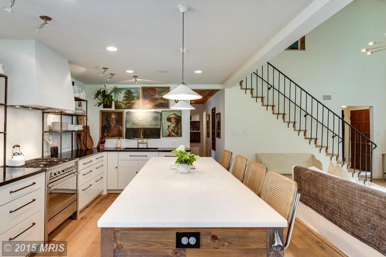 A kitchen with an island in the middle of a room