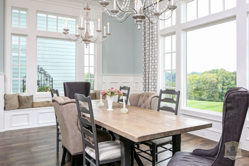 A dining room table in front of a window