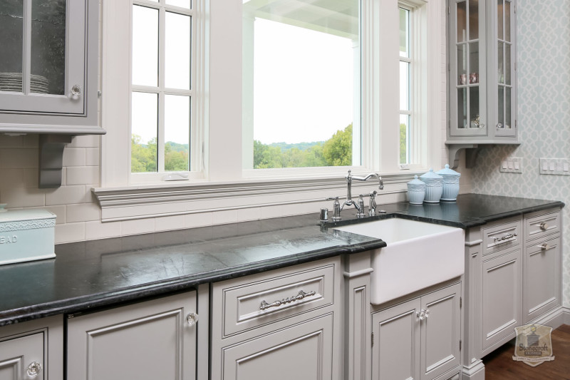 A kitchen with a sink and a window