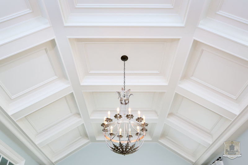 bedroom chandelier hanging from coffered ceiling