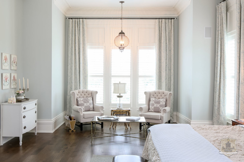 two upholstered chairs in bedroom window