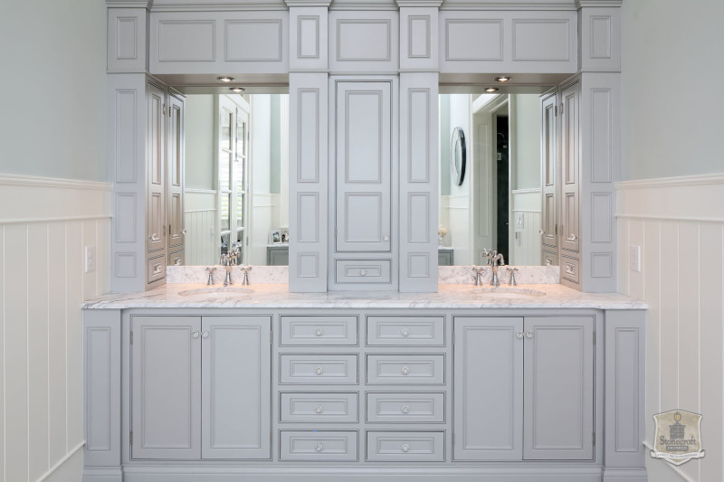 owner\'s bathroom with built in storage between two sinks