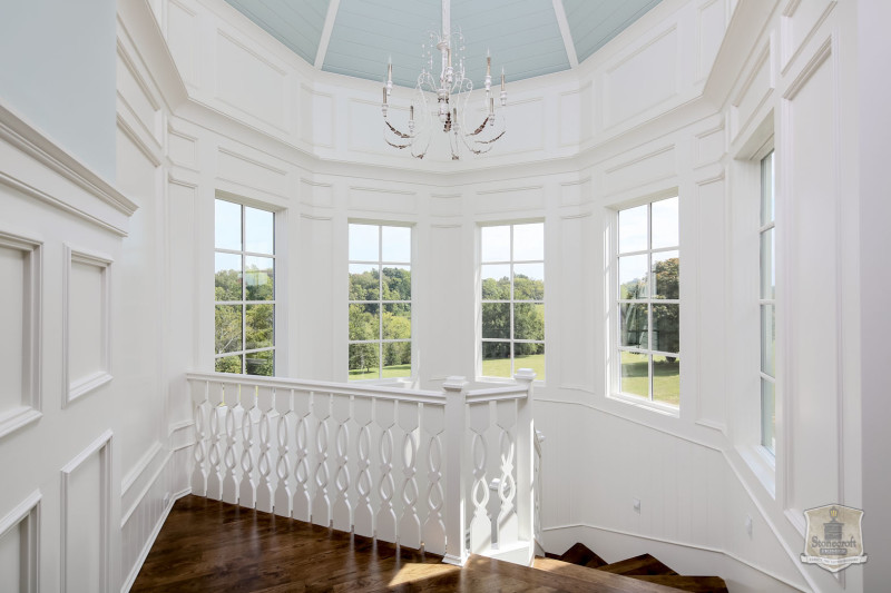 upstairs landing with chandelier and turret of windows