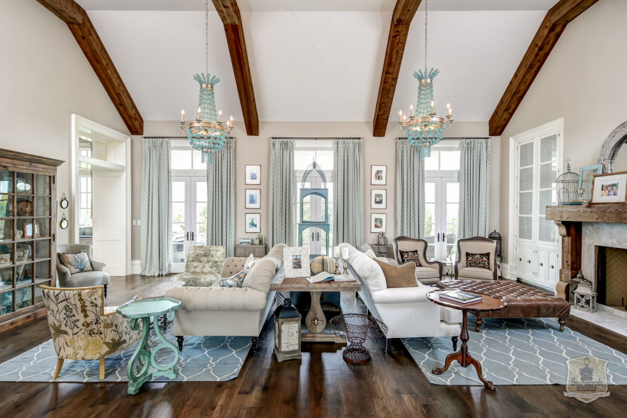 living room with two sofas and two chandeliers