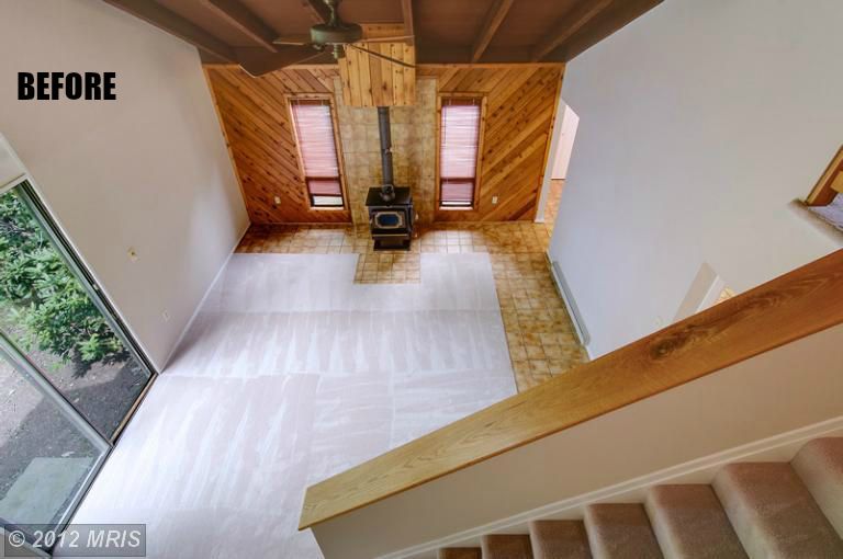 view of living room from second floor landing before remodel