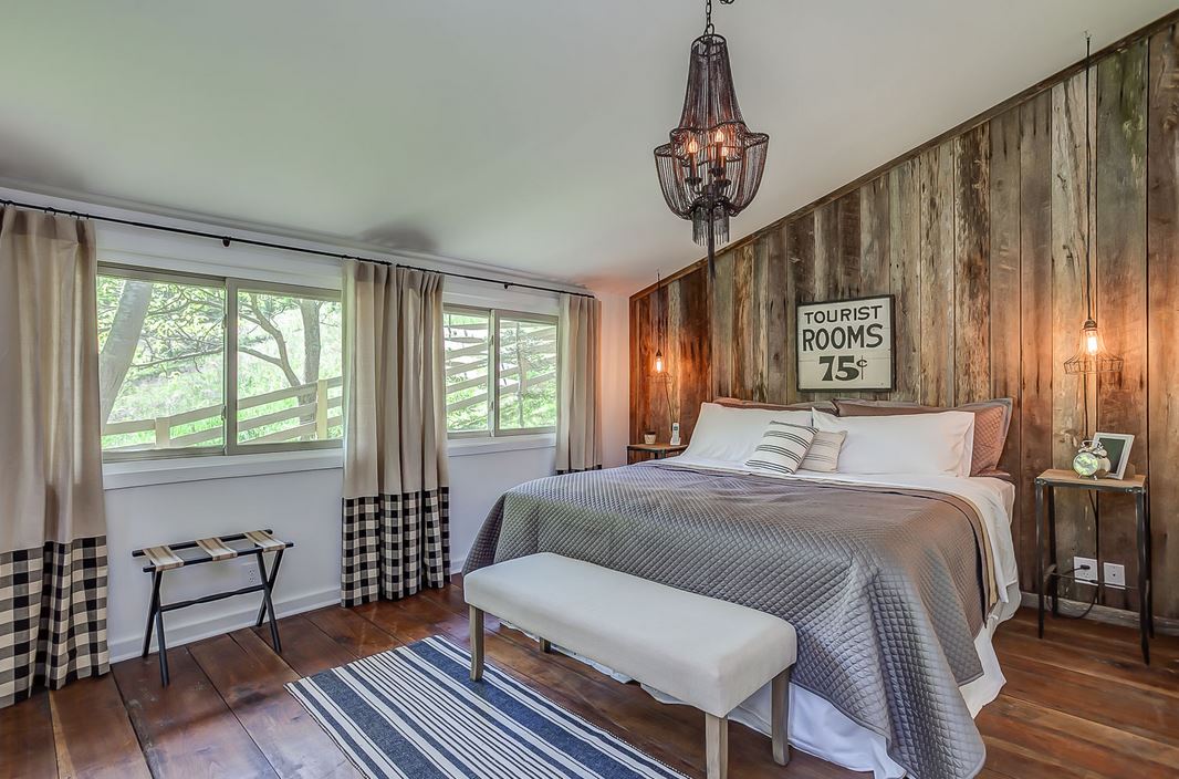 bedroom with reclaimed wood feature wall