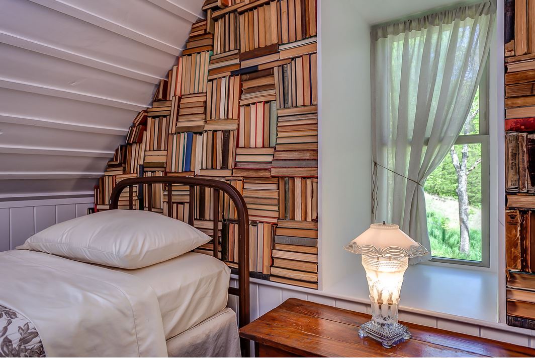 close up of books in space above bed