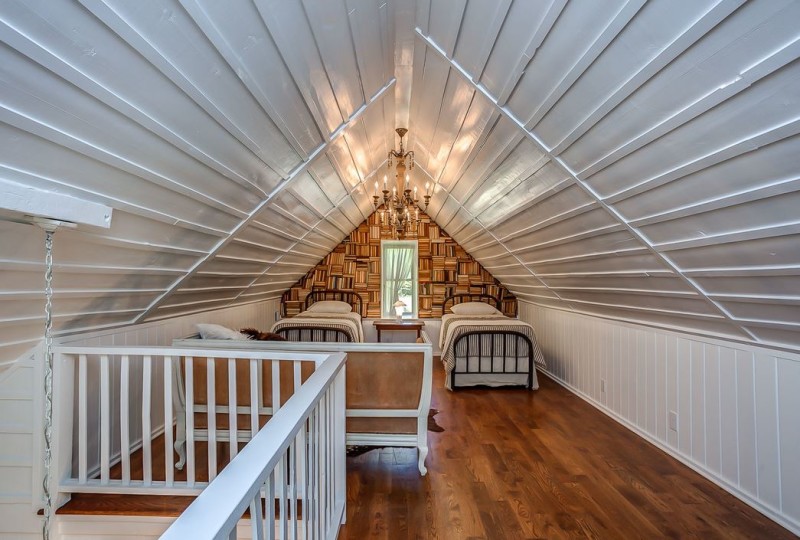 loft bedroom at top of stairs with two twin beds