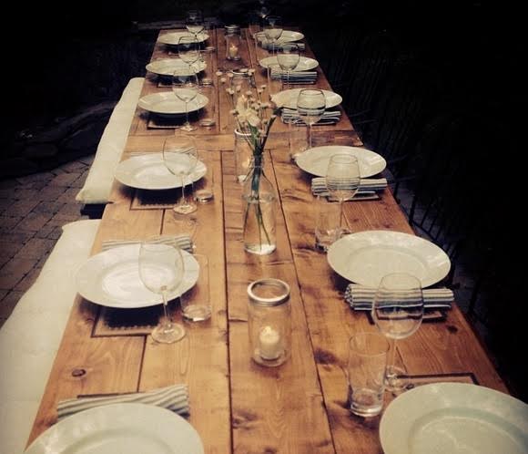 A table set with wine glasses and plates