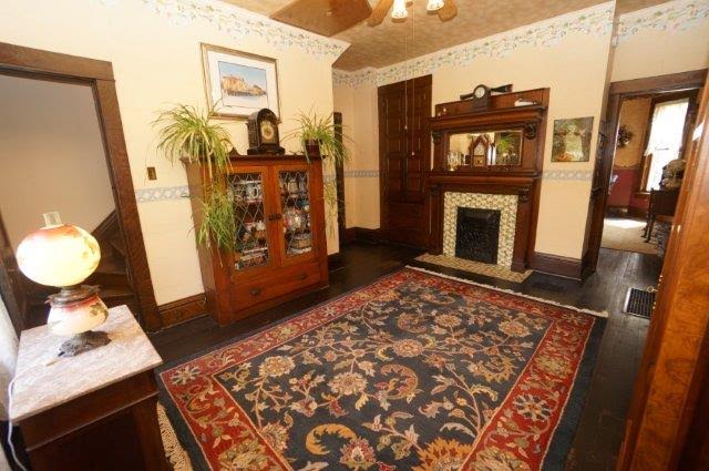 room with antique fireplace and area rug