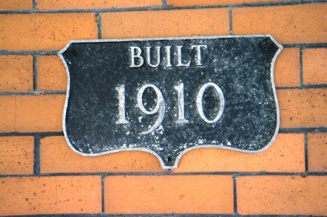 sign on front porch that says built in 1910