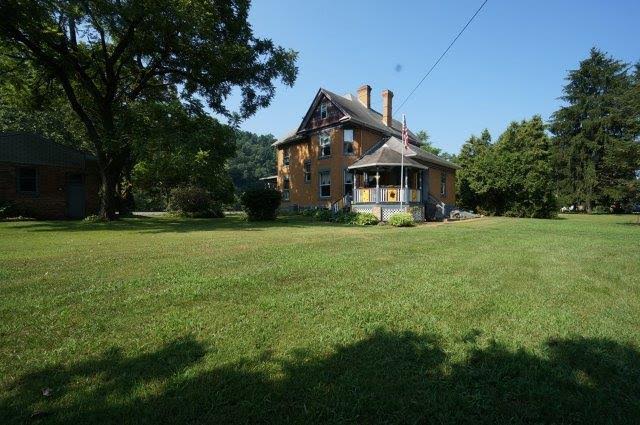 back exterior of house with gazebo and American flag