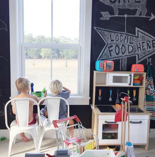 Playroom with black chalkboard wall and kitchen playset