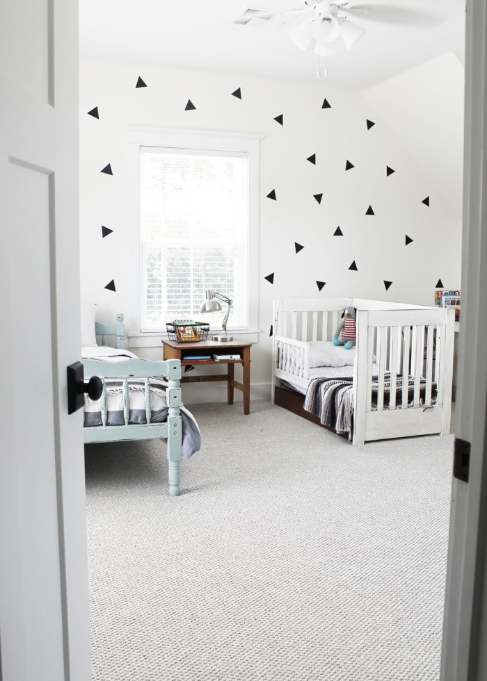 Boys\' bedroom with geometric wallpaper on feature wall