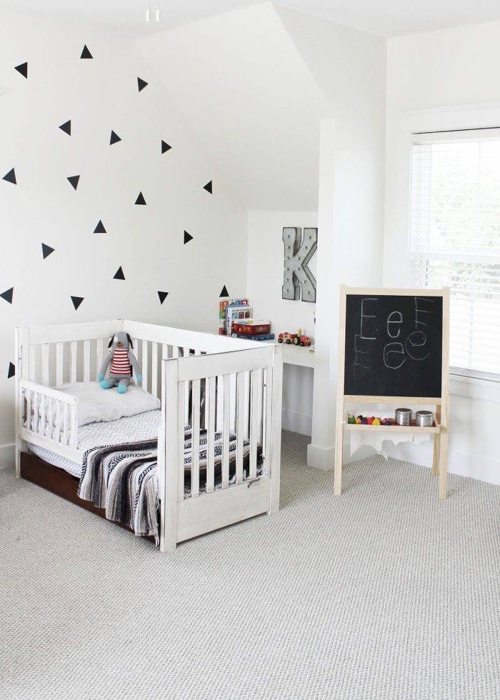 Toddler bed in boy\'s room with initial K on the wall