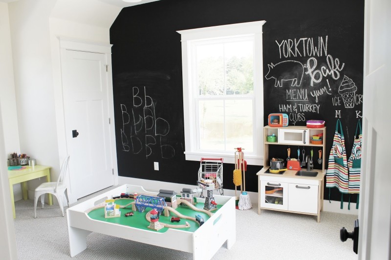 Playroom with black walls and train set