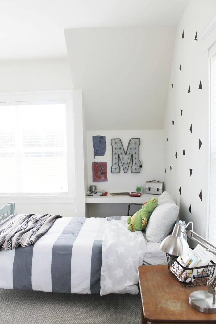 Boy\'s bedroom with initial M on wall beside bed