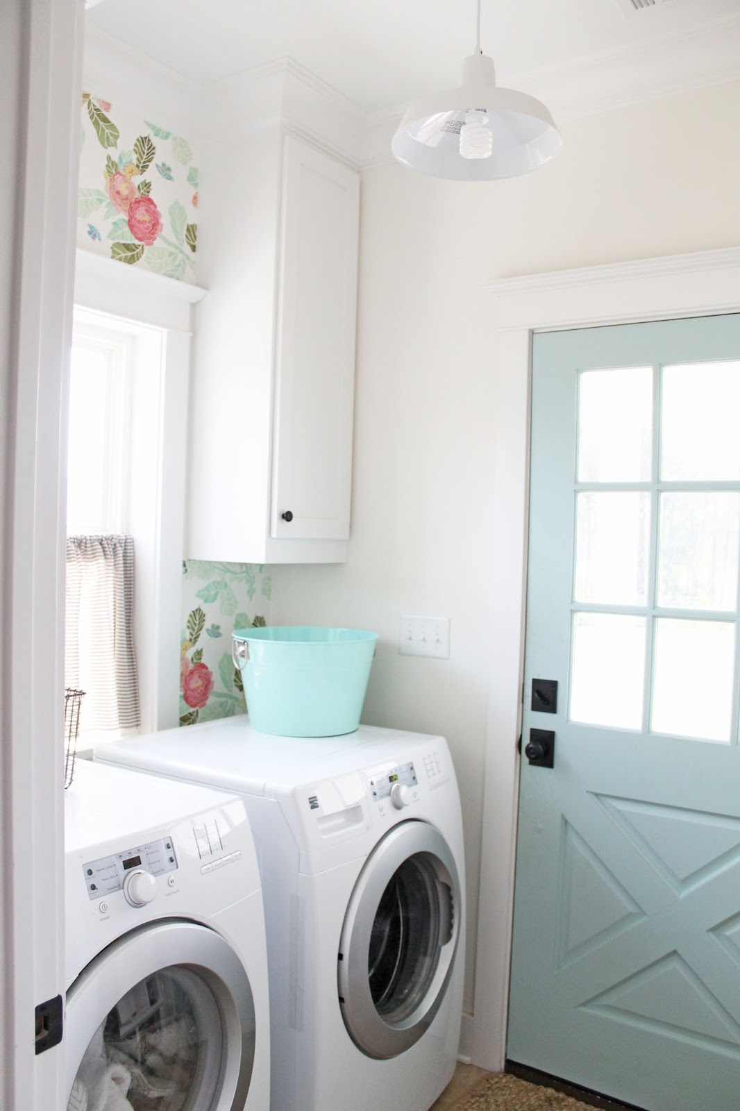 Laundry room with floral wallpaper