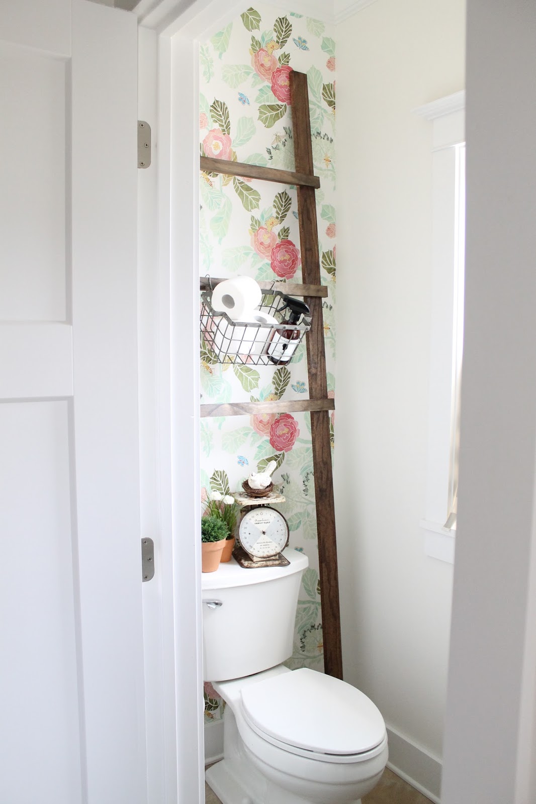 powder room with floral wallpaper and antique ladder