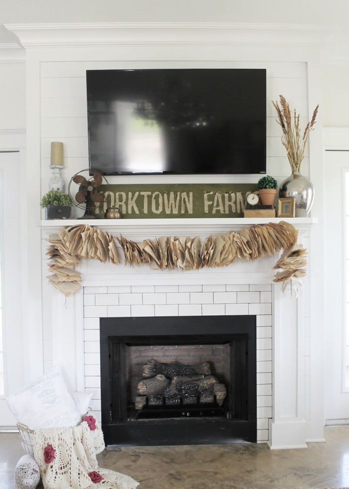 fireplace in living room with flat-screen TV above mantel