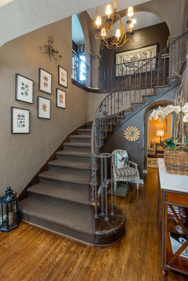 curving staircase after remodel with wrought iron railing