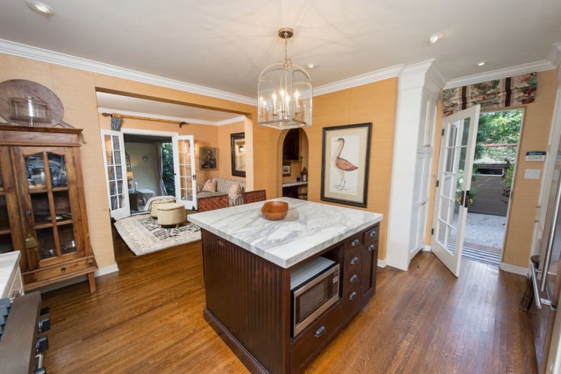 kitchen island with microwave and marble counter