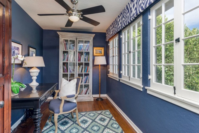 narrow study painted blue with desk and chair