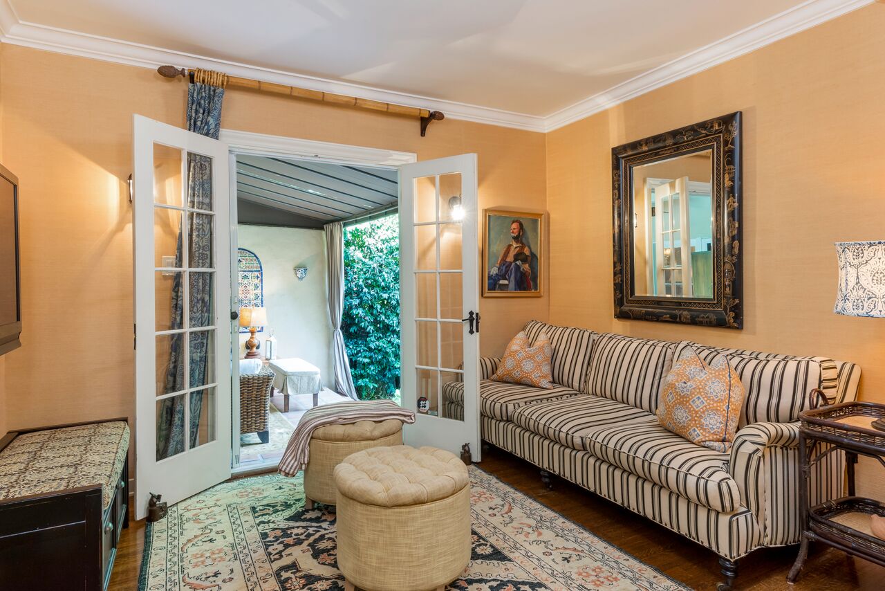 small sitting room with sofa and french doors open to patio