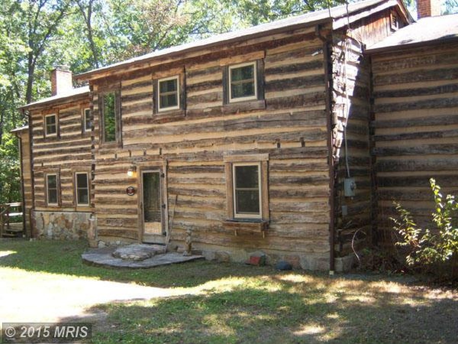 Front exterior of two story log house 