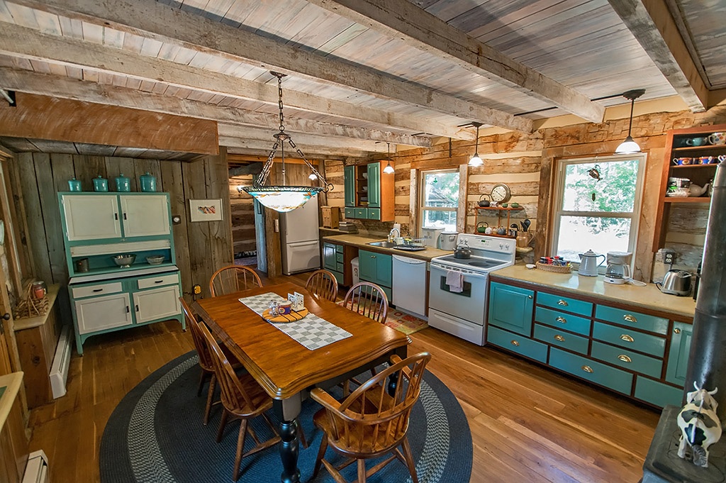 kitchen with table and chairs and turquoise painted cabinets