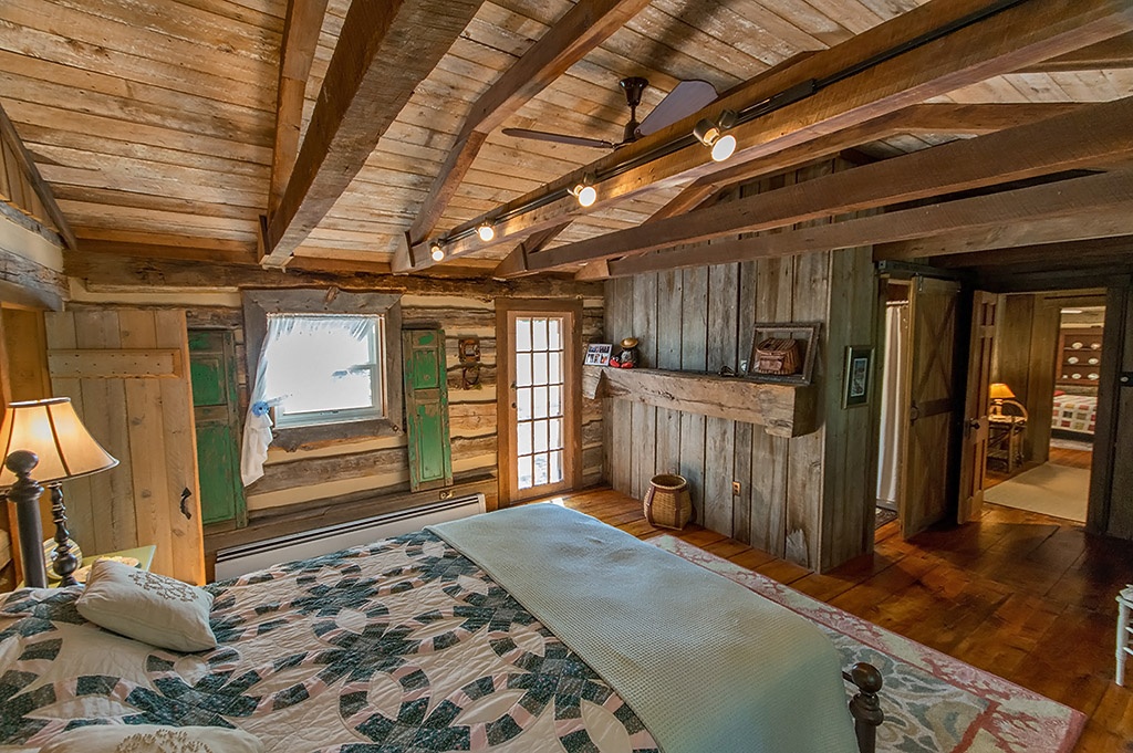 Bed with quilt in log cabin