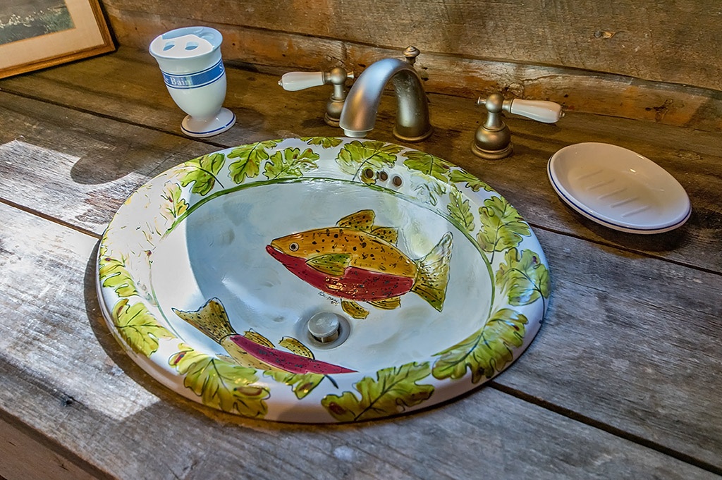 painted ceramic sink with picture of colorful fish in bowl