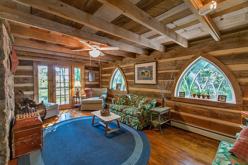 Sofa in floral fabric in log cabin