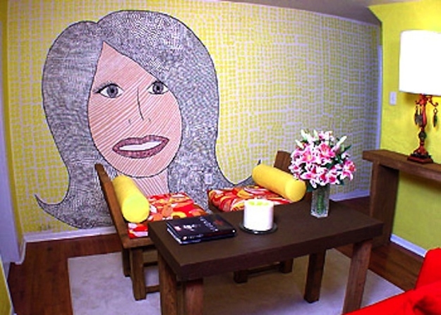 Hildi paints a mural of herself on a wall Trading Spaces