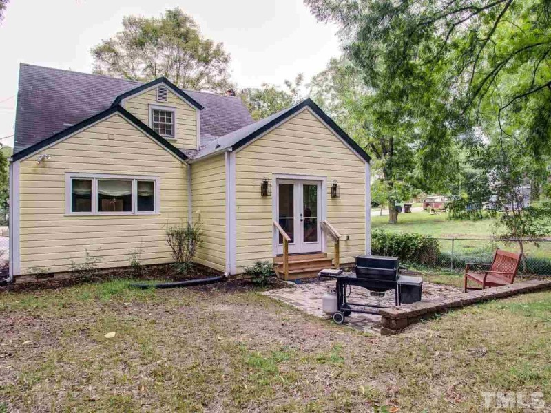 Back exterior of yellow bungalow on Love It or List It