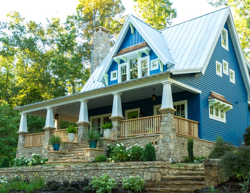 Front exterior of Craftsman style cottage with blue siding and front porch