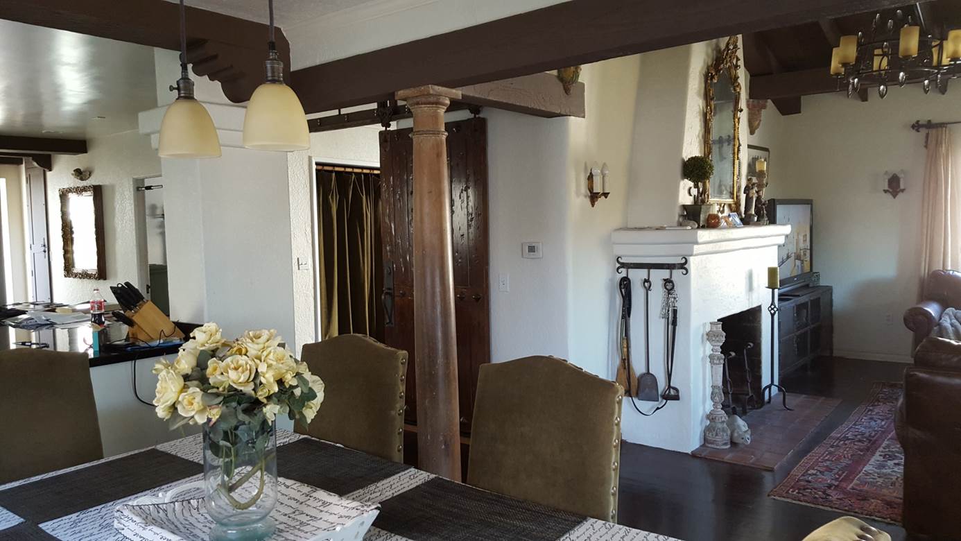 view from dining room of fireplace in living room